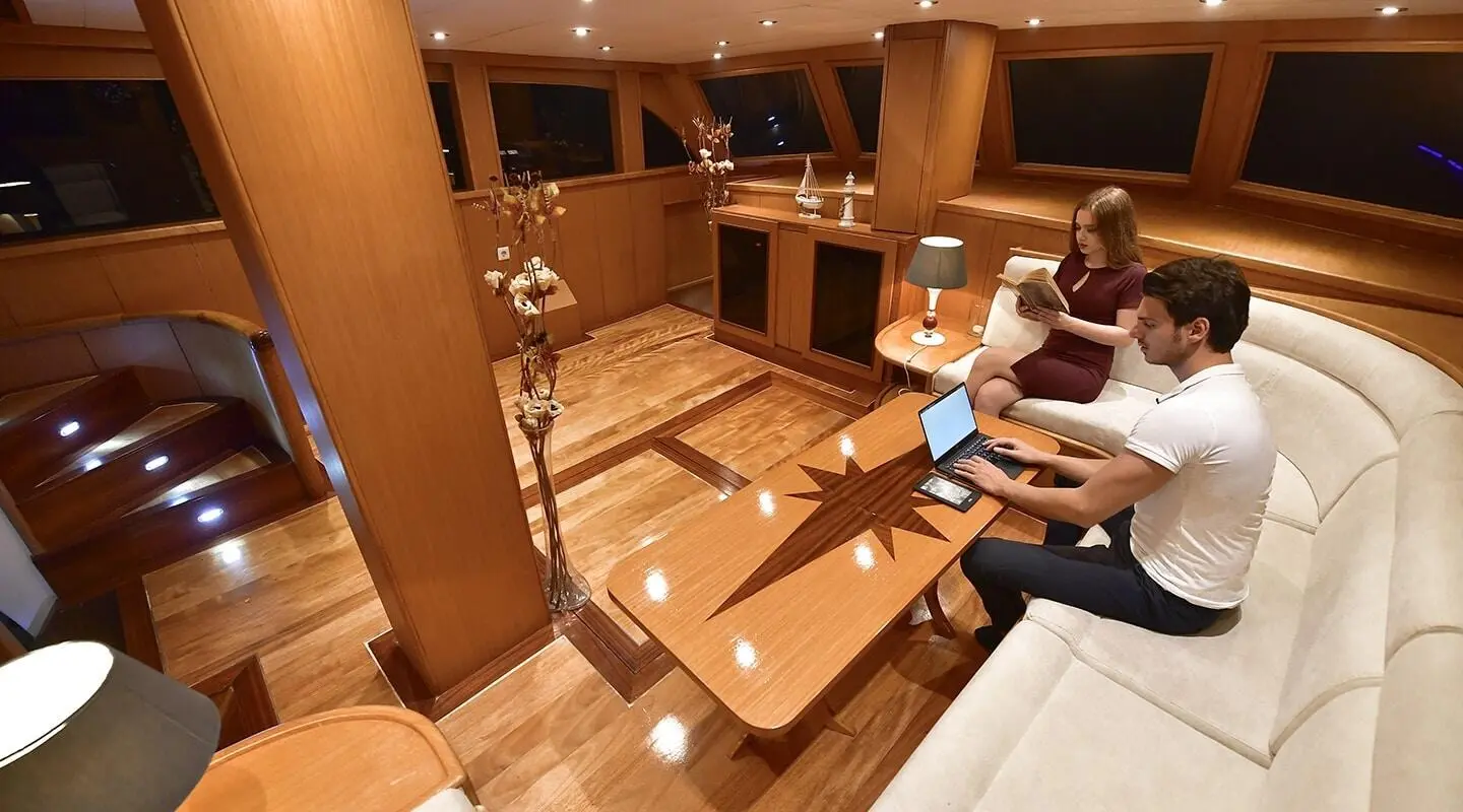 Interior of Blu Dream gulet with wooden dining table and seating