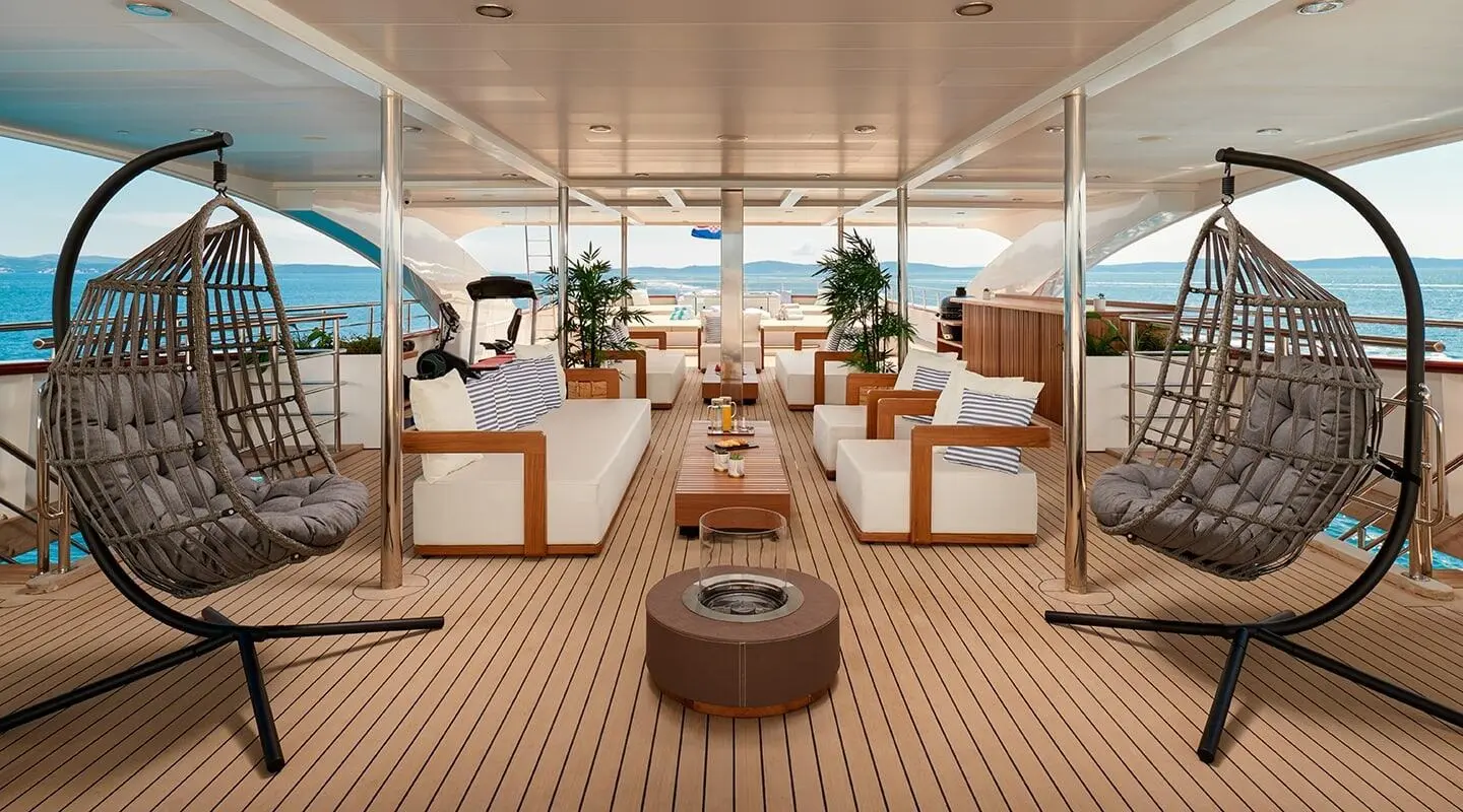Ohana yacht deck lounge area with seating, sun beds, and warm wooden flooring