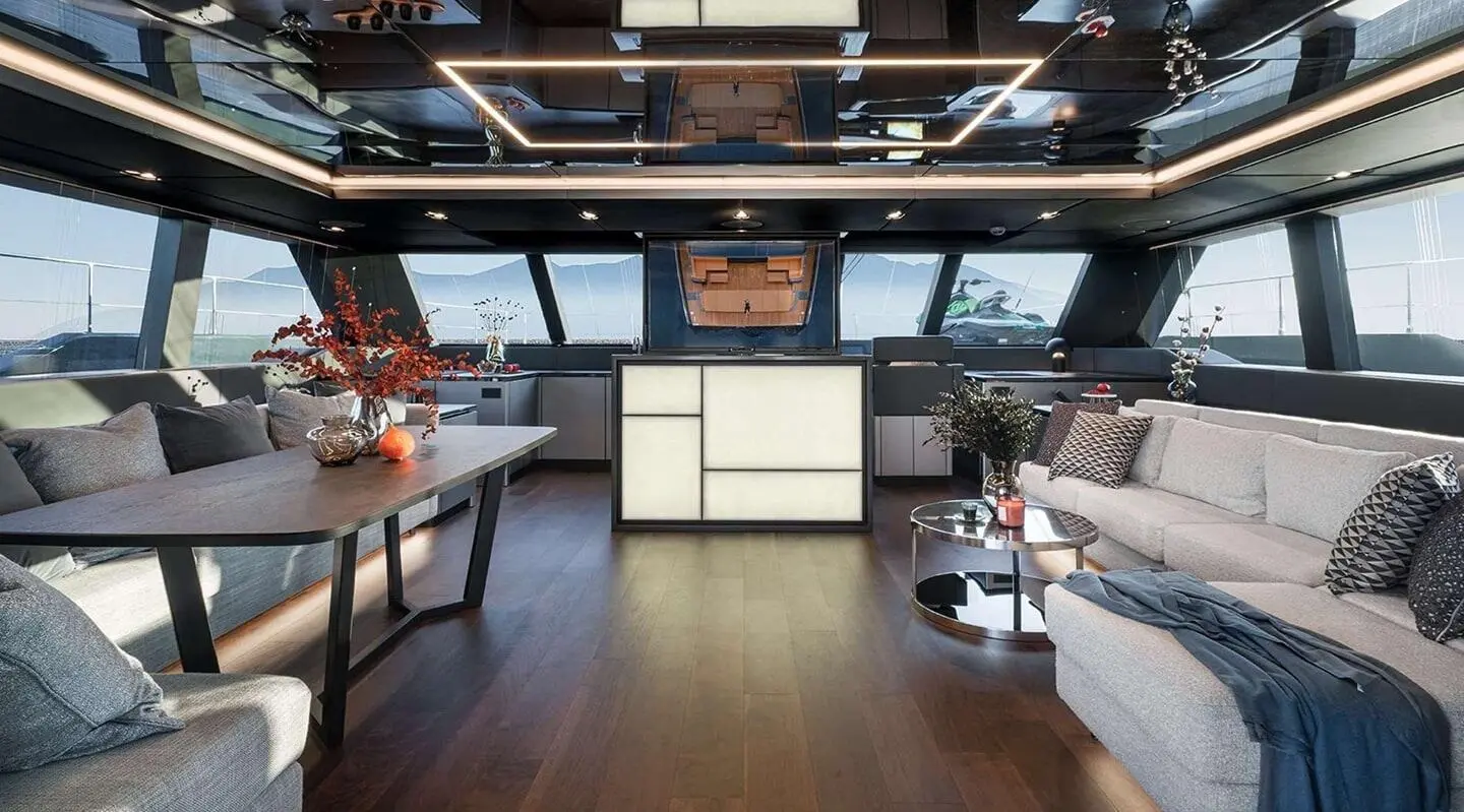 A cozy yacht lounge aboard Alteya with seating, tables, and sunset light