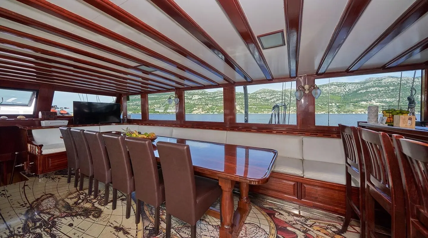 Gulet Stella Maris saloon interior with wooden beams and seating area