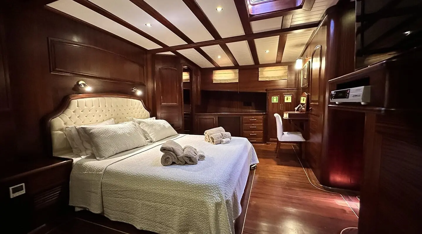 luxury yacht Arif Kaptan A interior with polished wood panels and beds