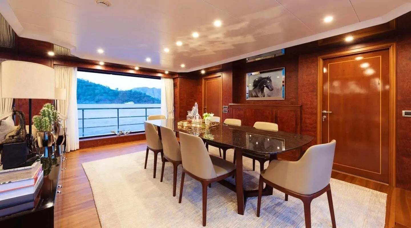 Ocean Breeze yacht Adamaris dining area with large glass balcony and view