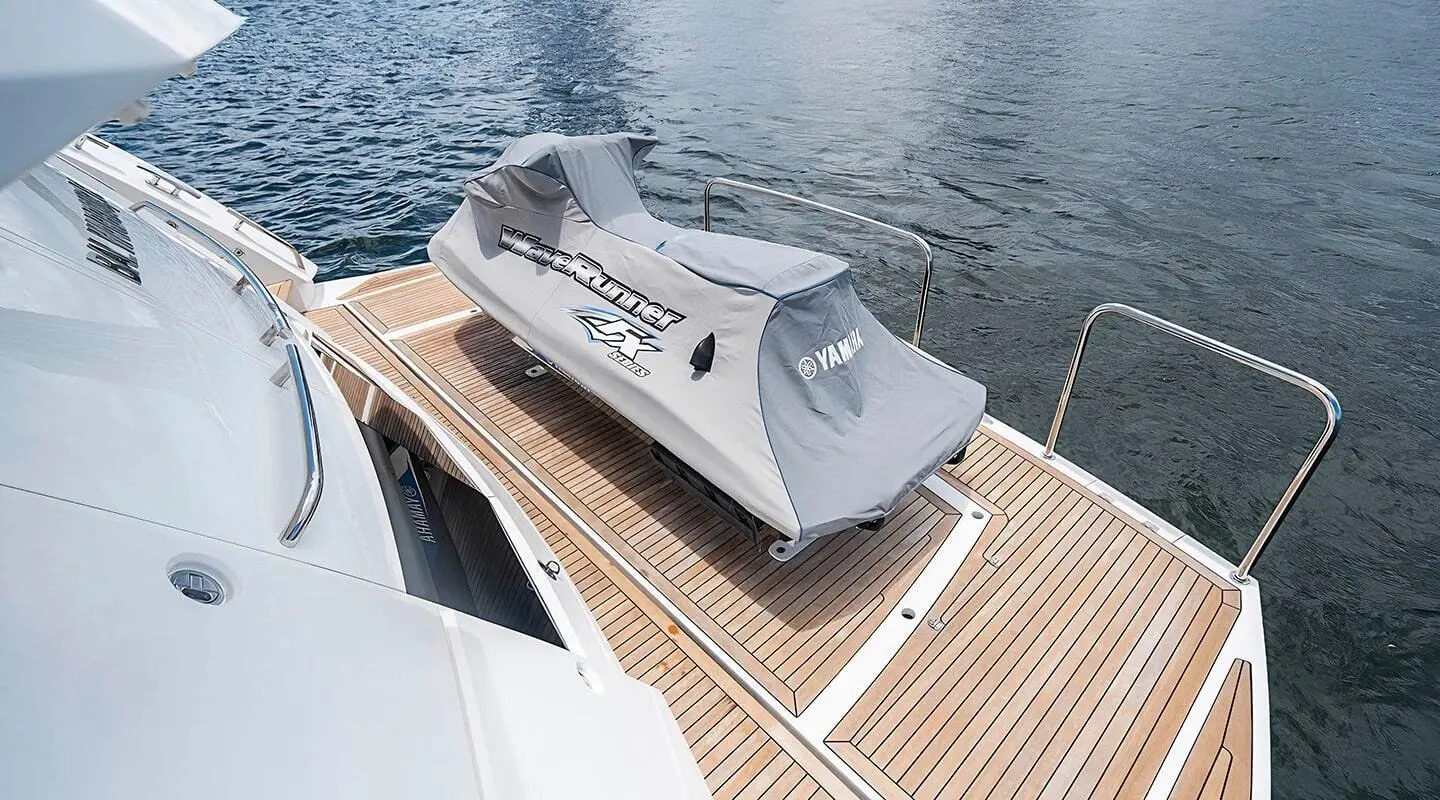 View of a luxury yacht Quantum deck with a shaded seating area and wooden planks