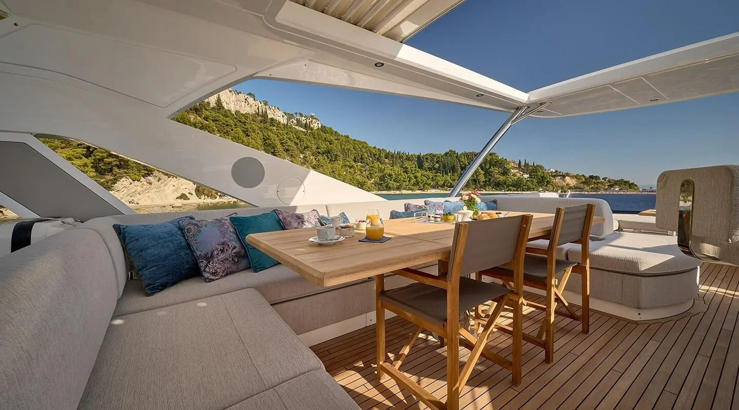 Yacht Hideaway outdoor dining area with wooden table and seating under a canopy
