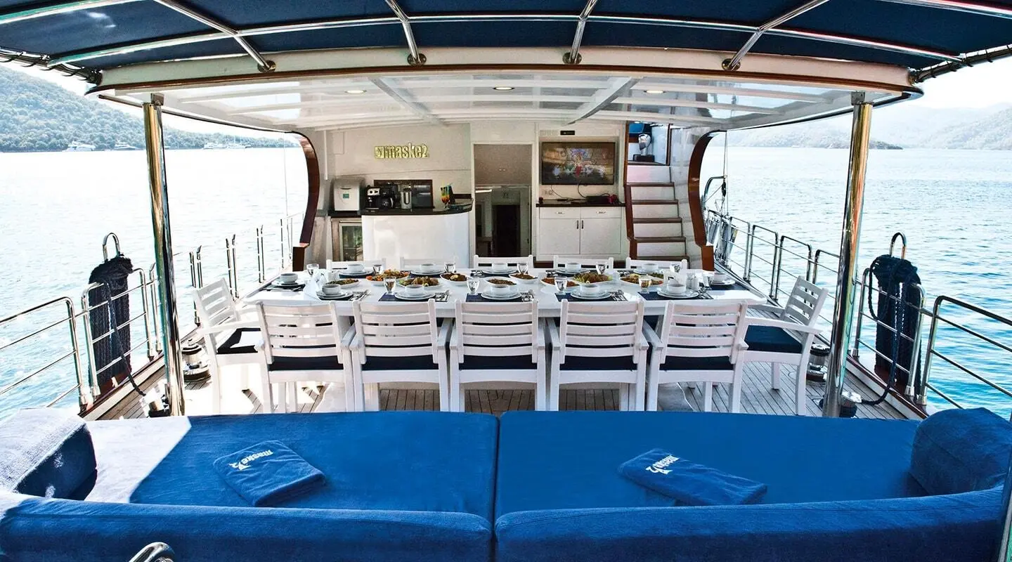 Gulet Maske 2 aft deck with seating and table on open area