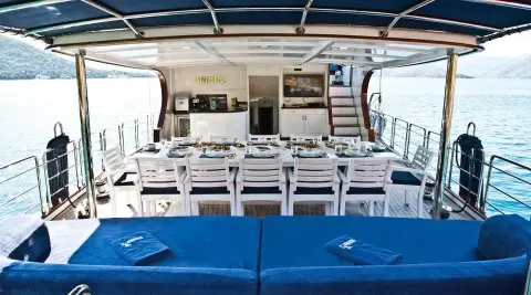 Gulet Maske 2 aft deck with seating and table on open area