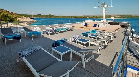 Lupus Mare yacht sun deck with loungers and cushions