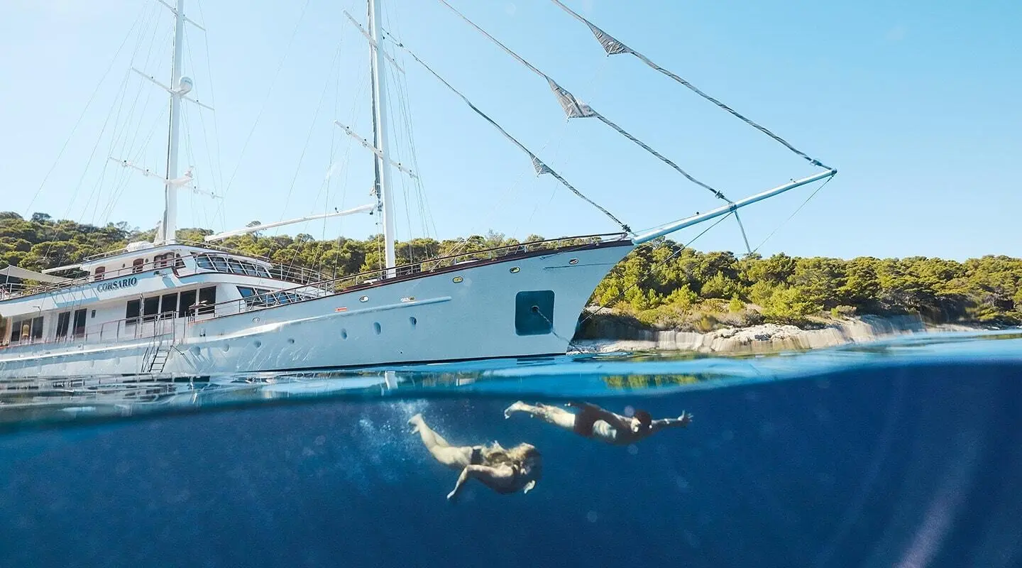 Corsario yacht moored at sunset with white hull and blue water