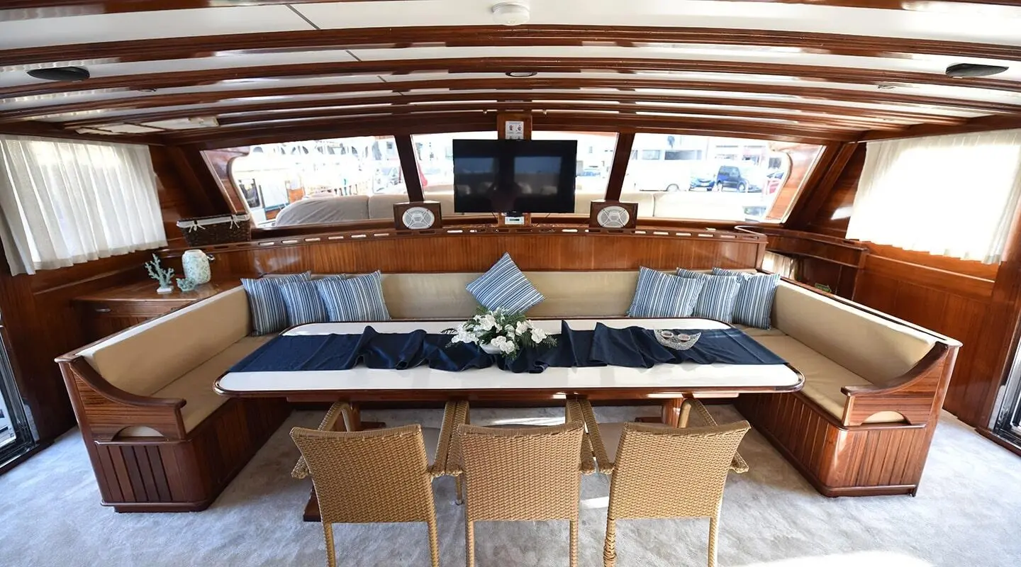Kayhan Kaptan yacht interior: sunlit helm seating area with blue cushions