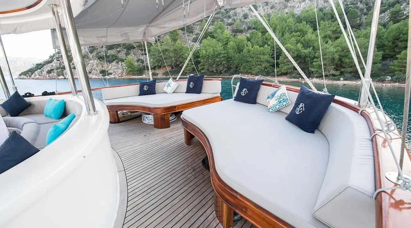 Vista Mare yacht deck seating with white cushions and ropes at sunset