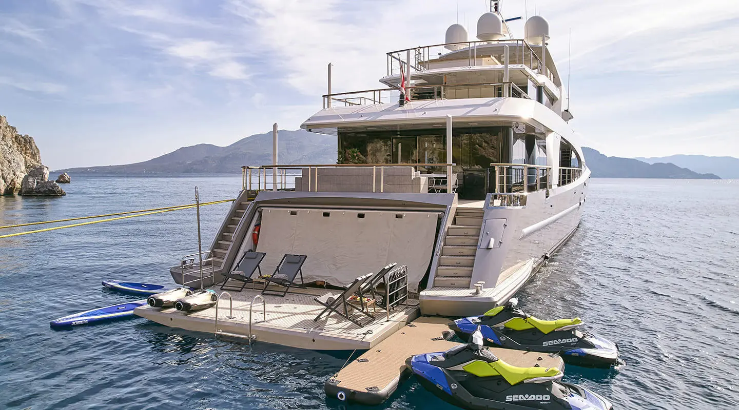 Yacht La Pellegrina 1 docked with stairs, decks, and lifeboats visible