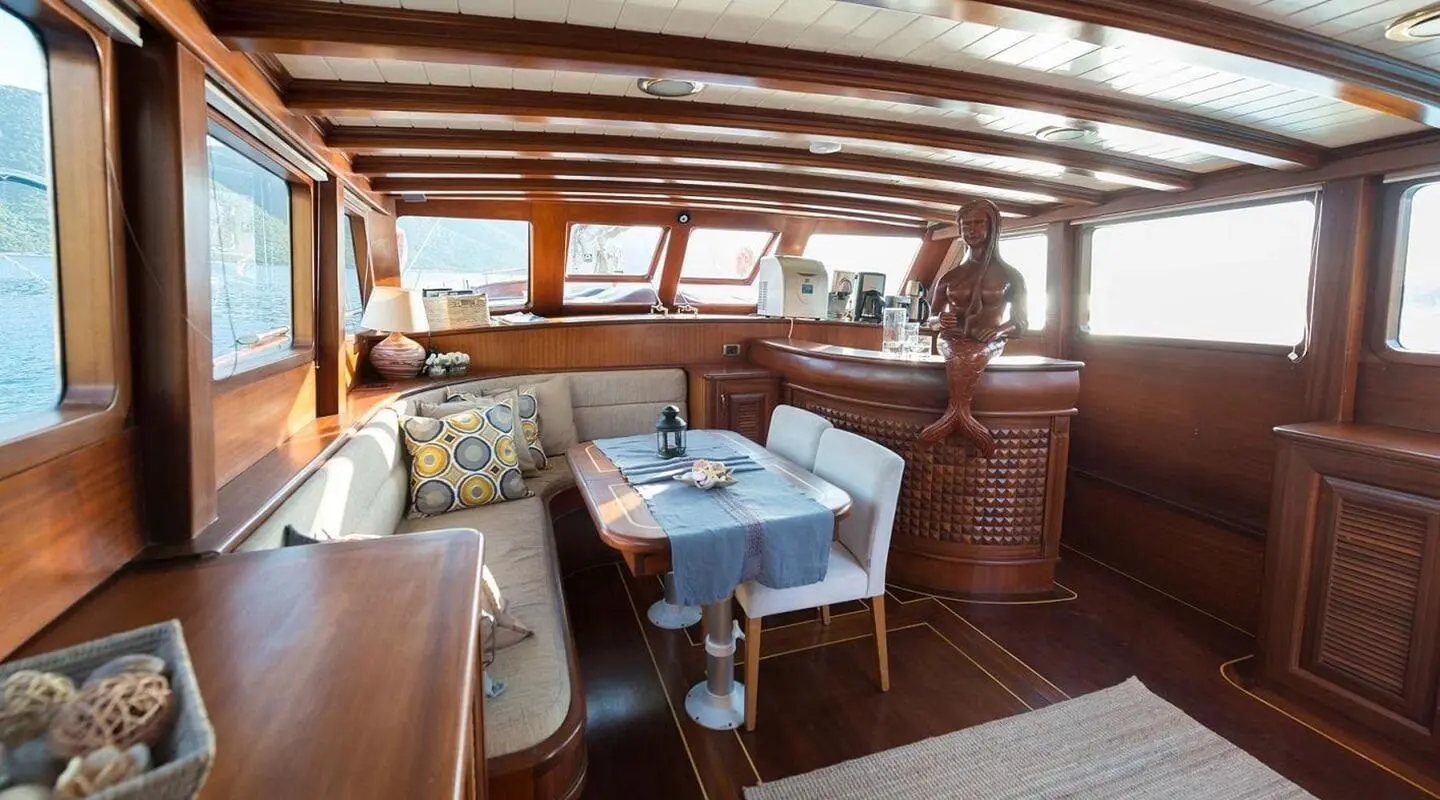 Primadonna yacht interior on deck with table set for sunset dining