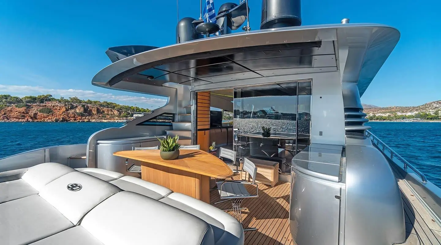 Aft deck of a Motoryat One yacht with wood decking, seating, and sun loungers