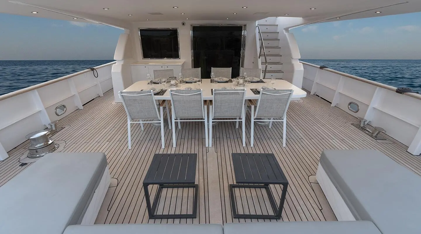Aft deck of Project Steel yacht with seating and two steps leading down