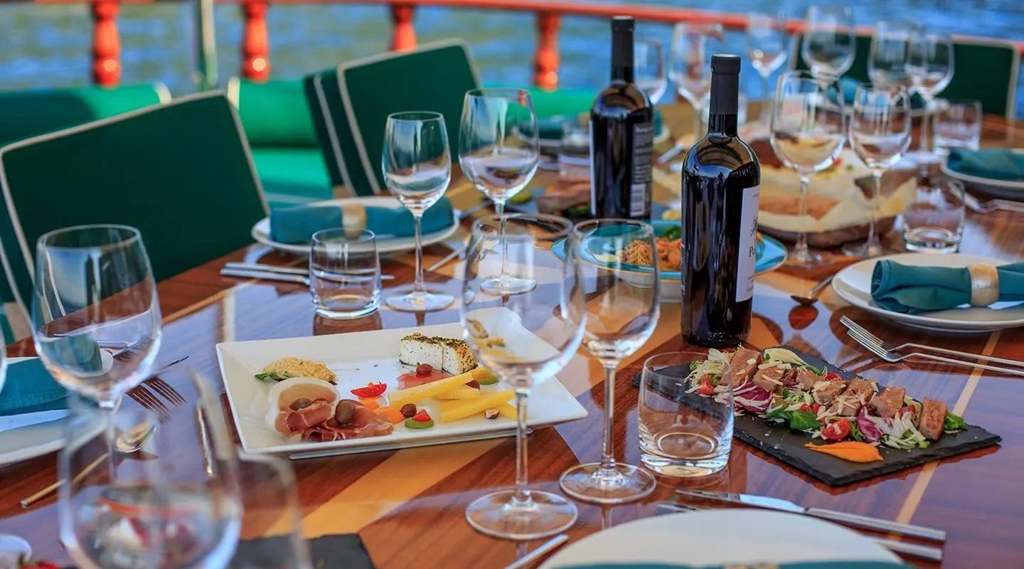 Gulet Carpe Diem 7 with dining setup on deck and beverages
