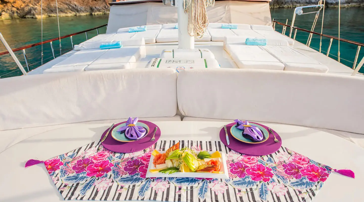 Sunset view from the Mein Schatz yacht with a vibrant table setting and chairs