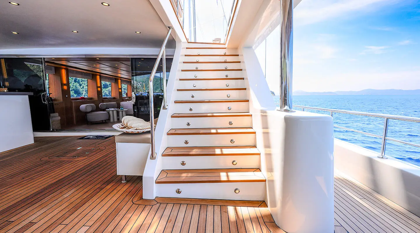 Staircase on luxury yacht deck with polished wood treads and railings