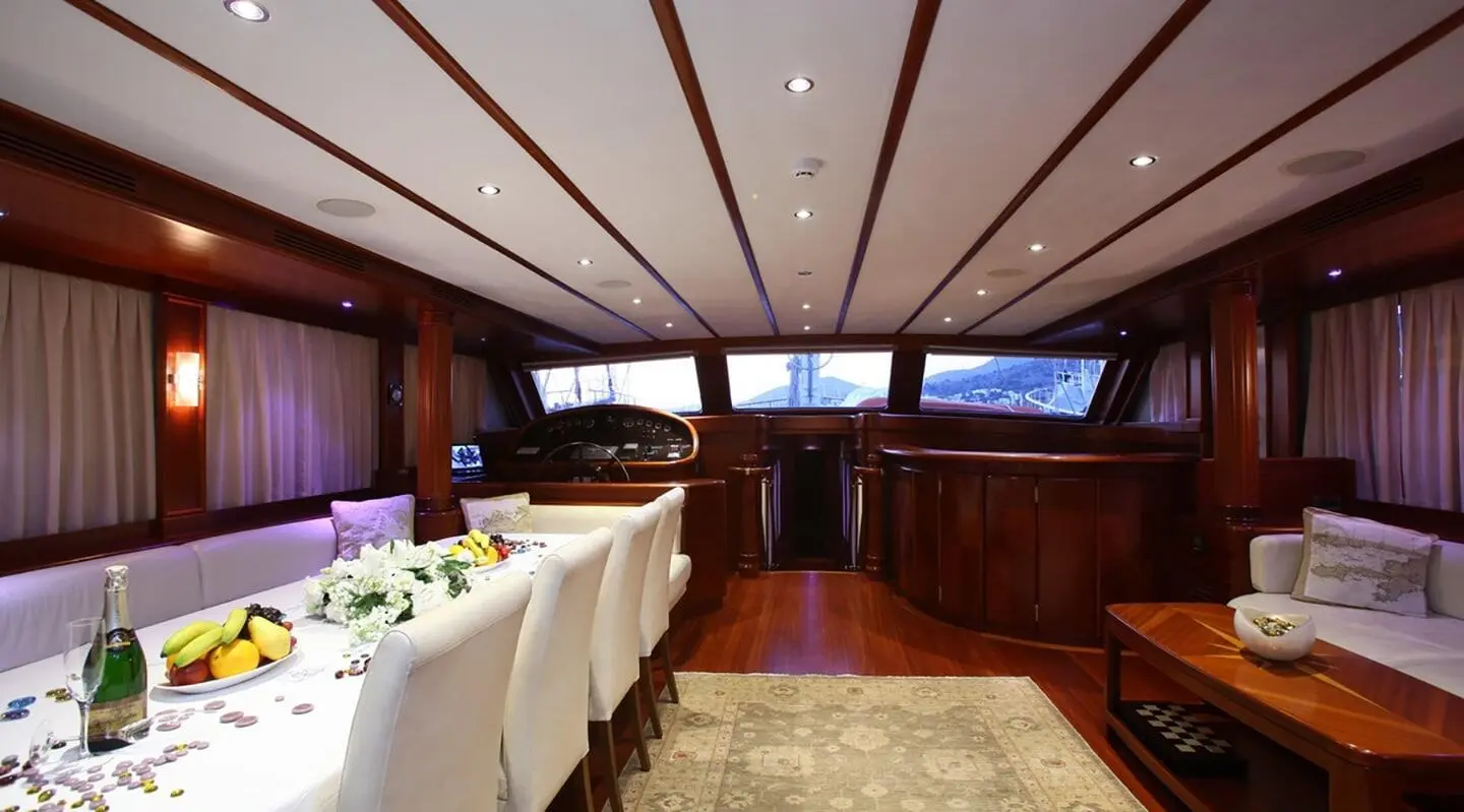 Interior of Kaya Guneri 5 yacht with dining table set and windows view