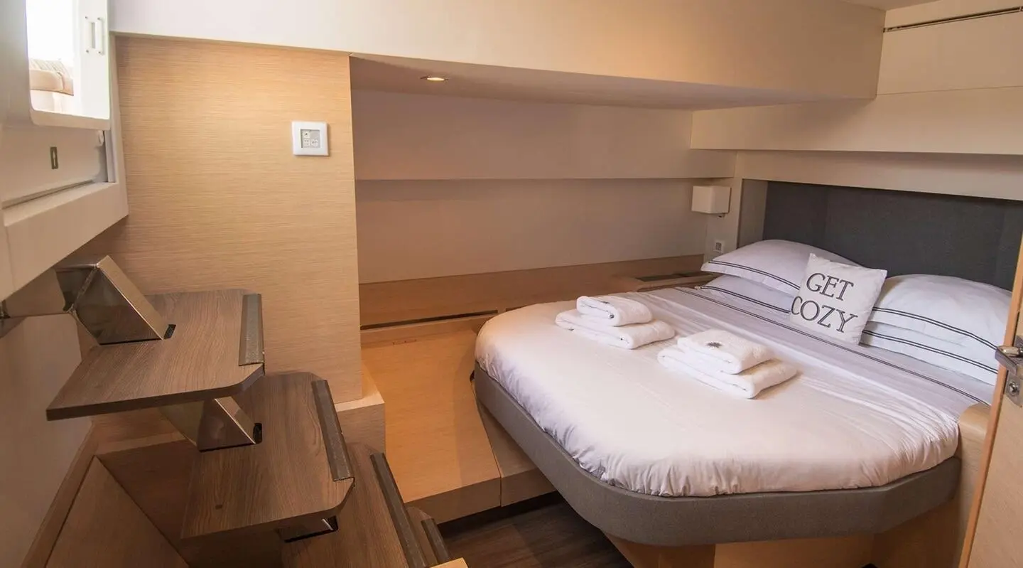Serenissima yacht bedroom with two twin beds, wooden cabinets, and soft lighting
