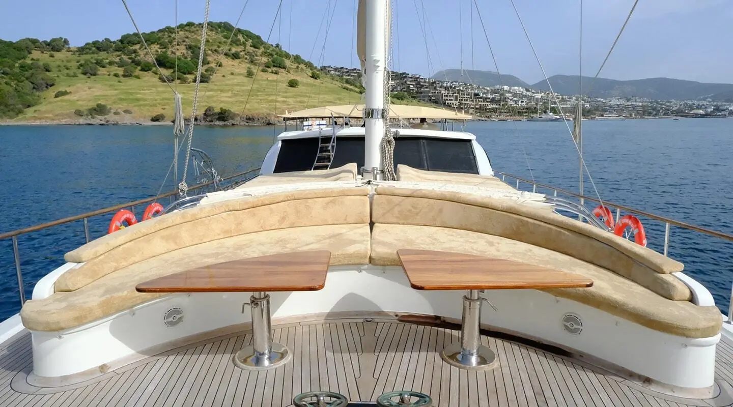 Bow of a wooden gulet with pale wood hull and deck railings, Queen Of Sea