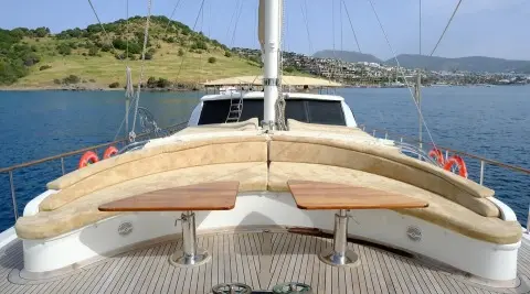 Bow of a wooden gulet with pale wood hull and deck railings, Queen Of Sea