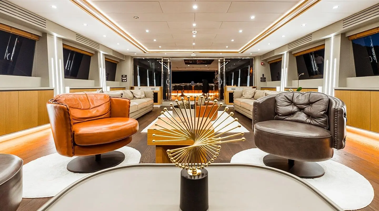 Luxurious yacht salon with colorful armchairs and a central decorative piece