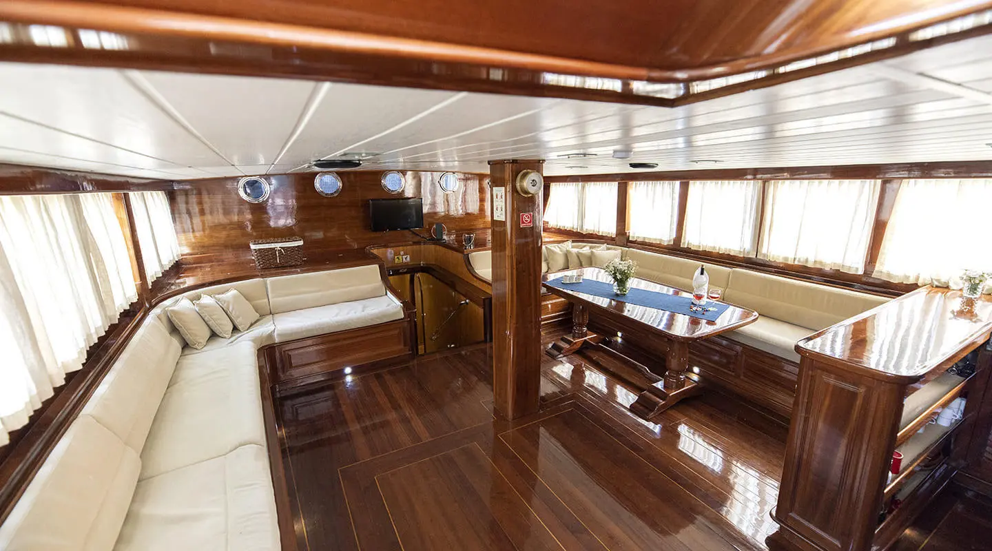 Kayhan 8 luxury gulet yacht interior with polished wooden deck and seating