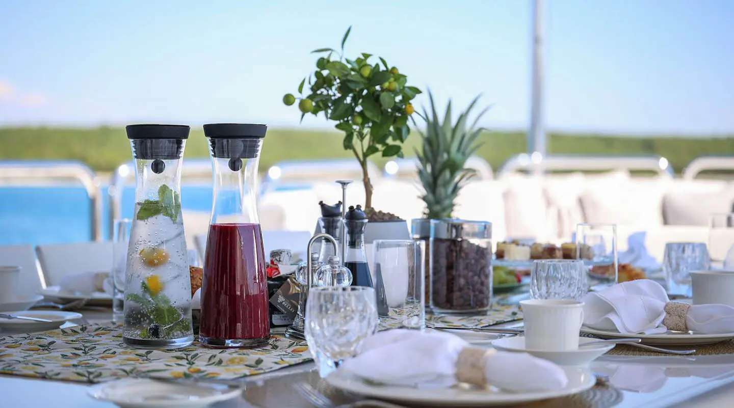 Table setting and beverages on Alalya yacht exterior