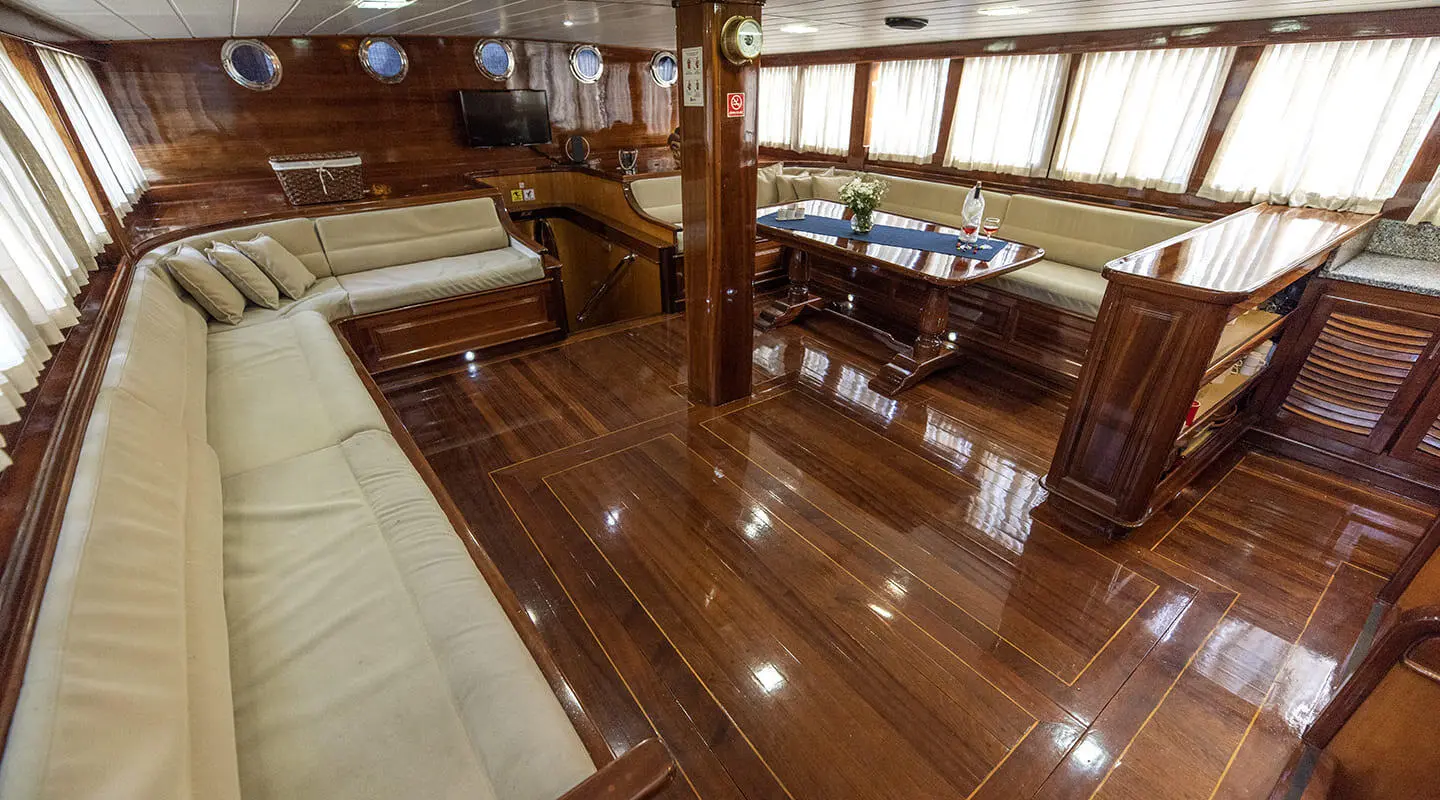 Kayhan 8 yacht charter interior with polished wooden deck and seating area