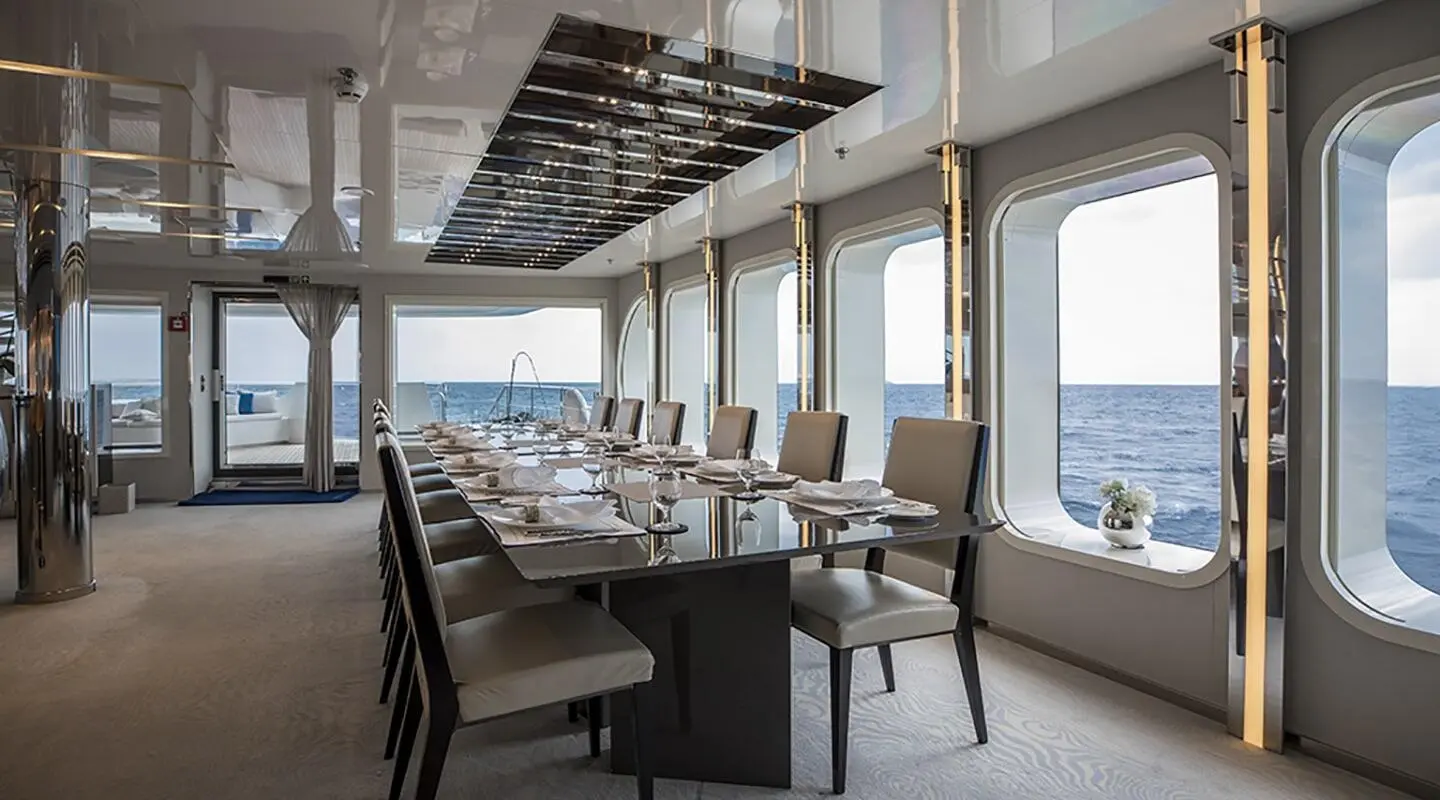 Marquise yacht interior dining area with panoramic ocean views through large windows