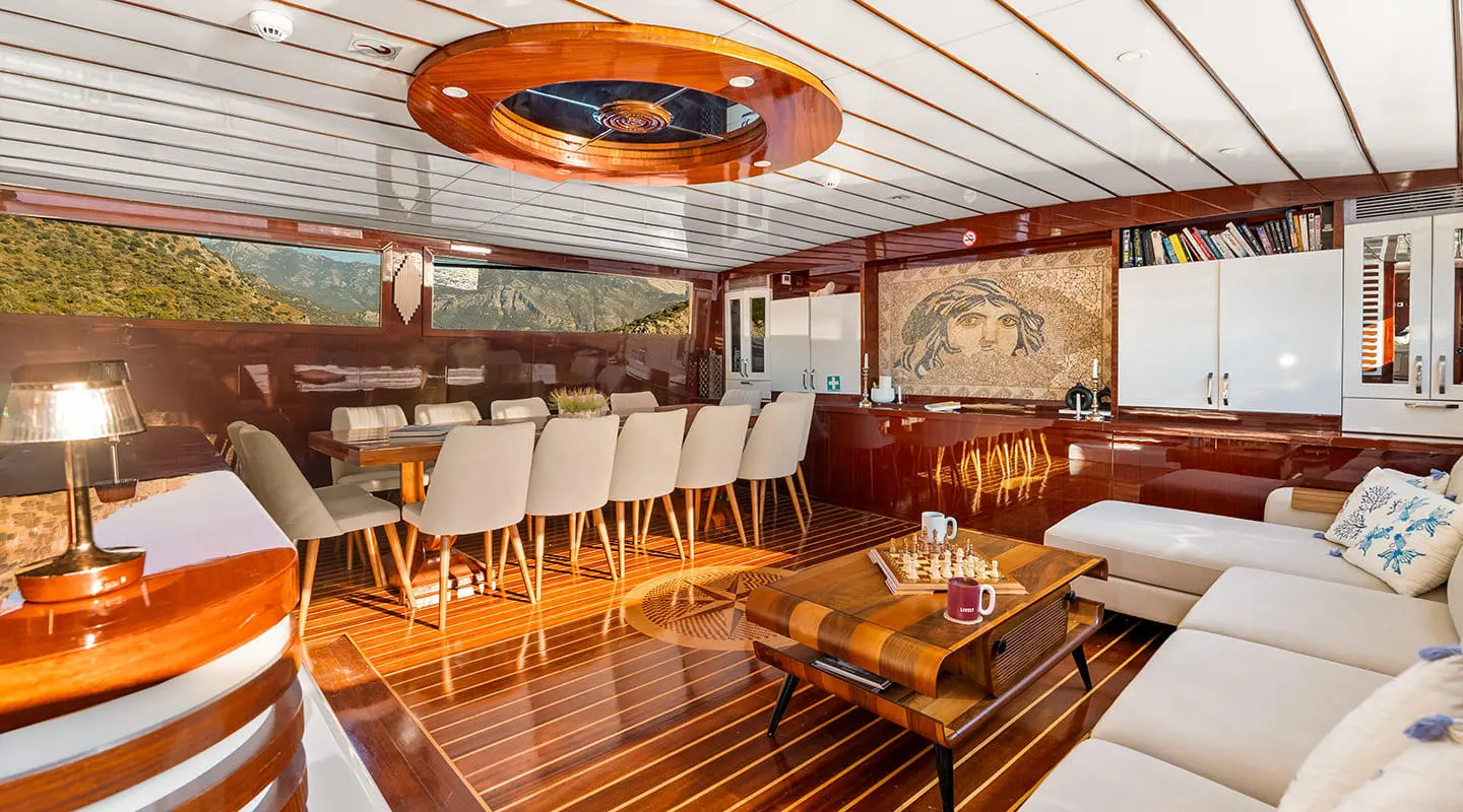Interior of Esma Sultan gulet saloon with wooden deck seating and cabinets