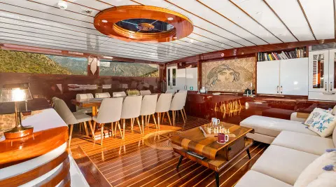 Interior of Esma Sultan gulet saloon with wooden deck seating and cabinets