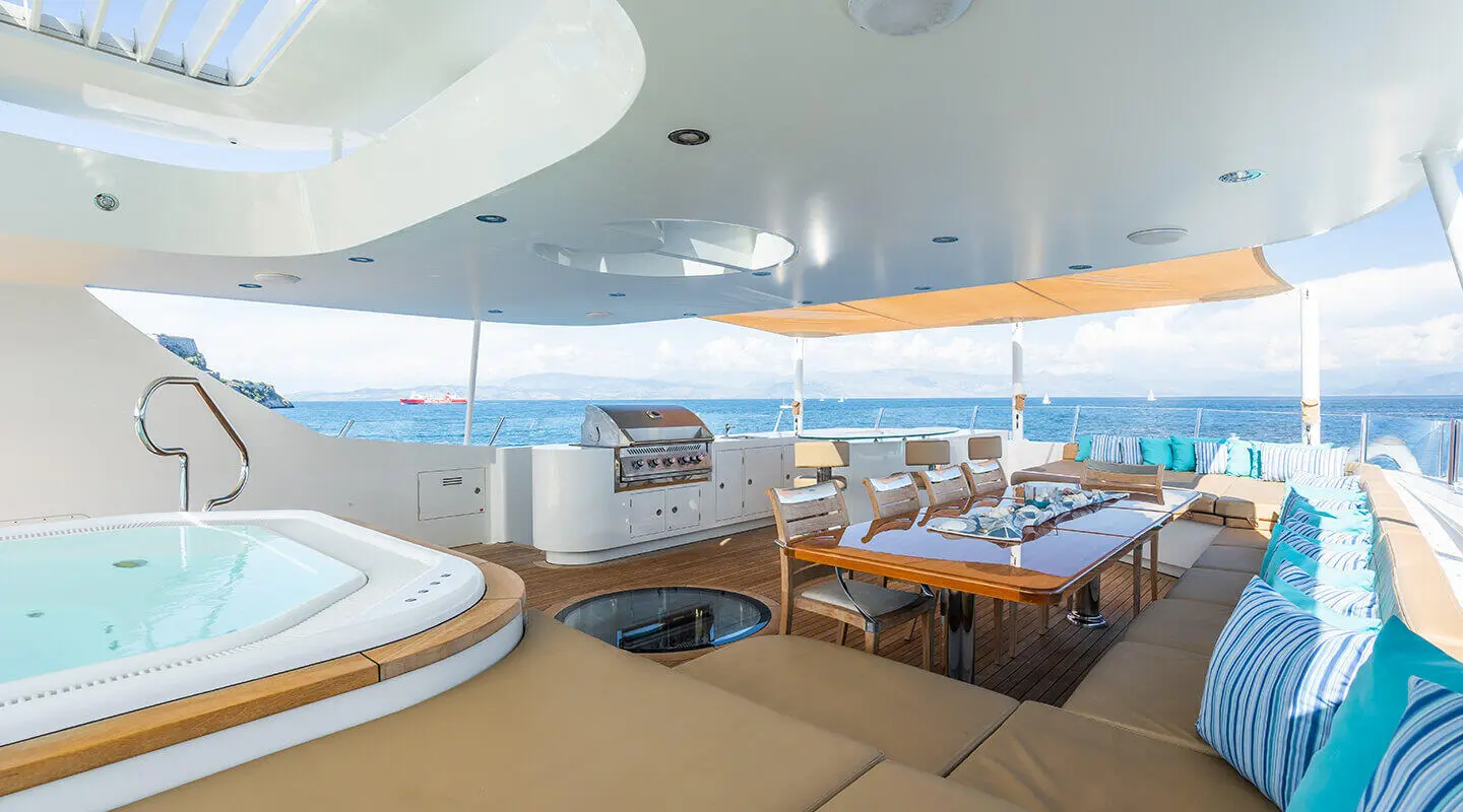 Serenity yacht interior deck seating with round sunken lounge and ocean view