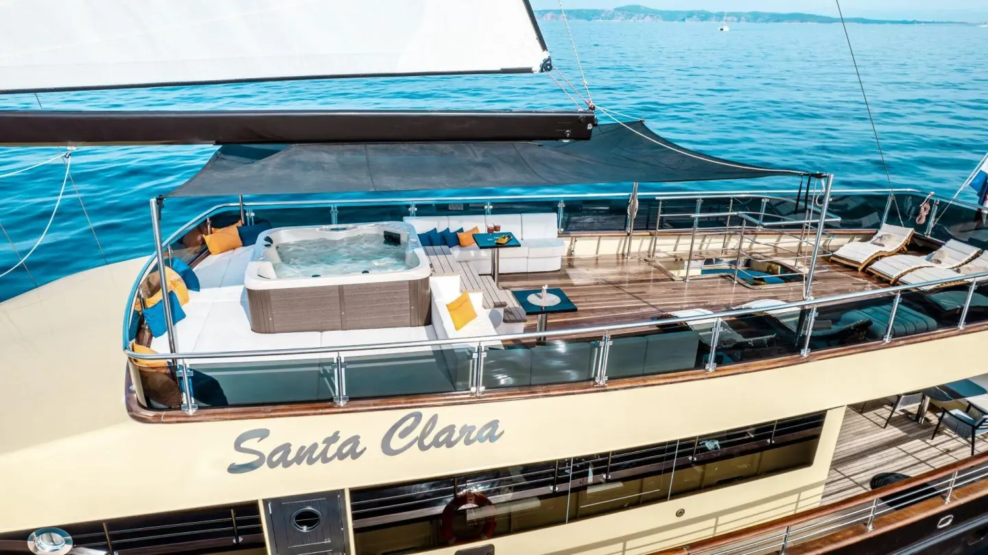 Santa Clara luxury yacht deck with people, railing, and water backdrop