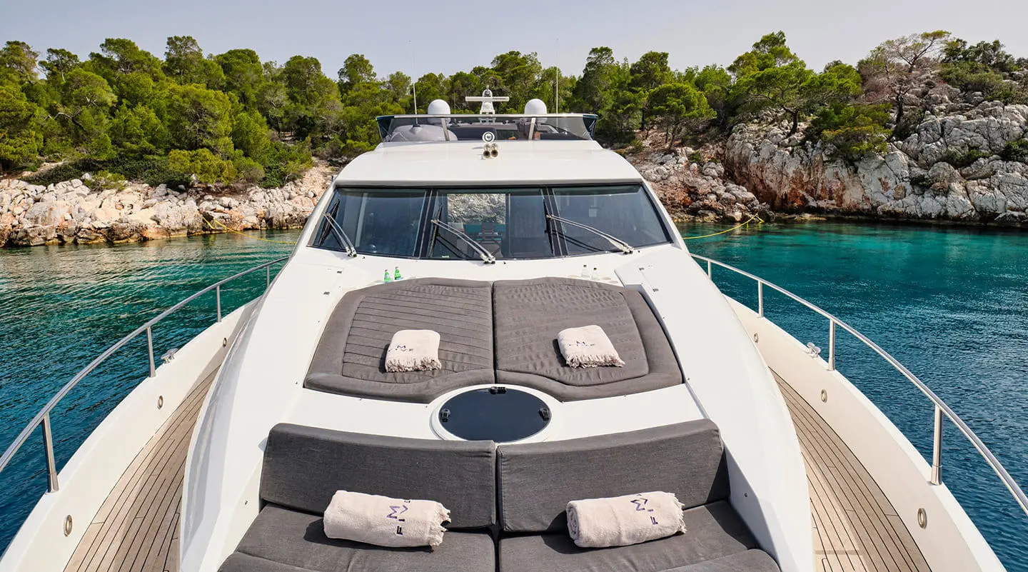 Top deck of M Five yacht with sun loungers and seating area outdoors