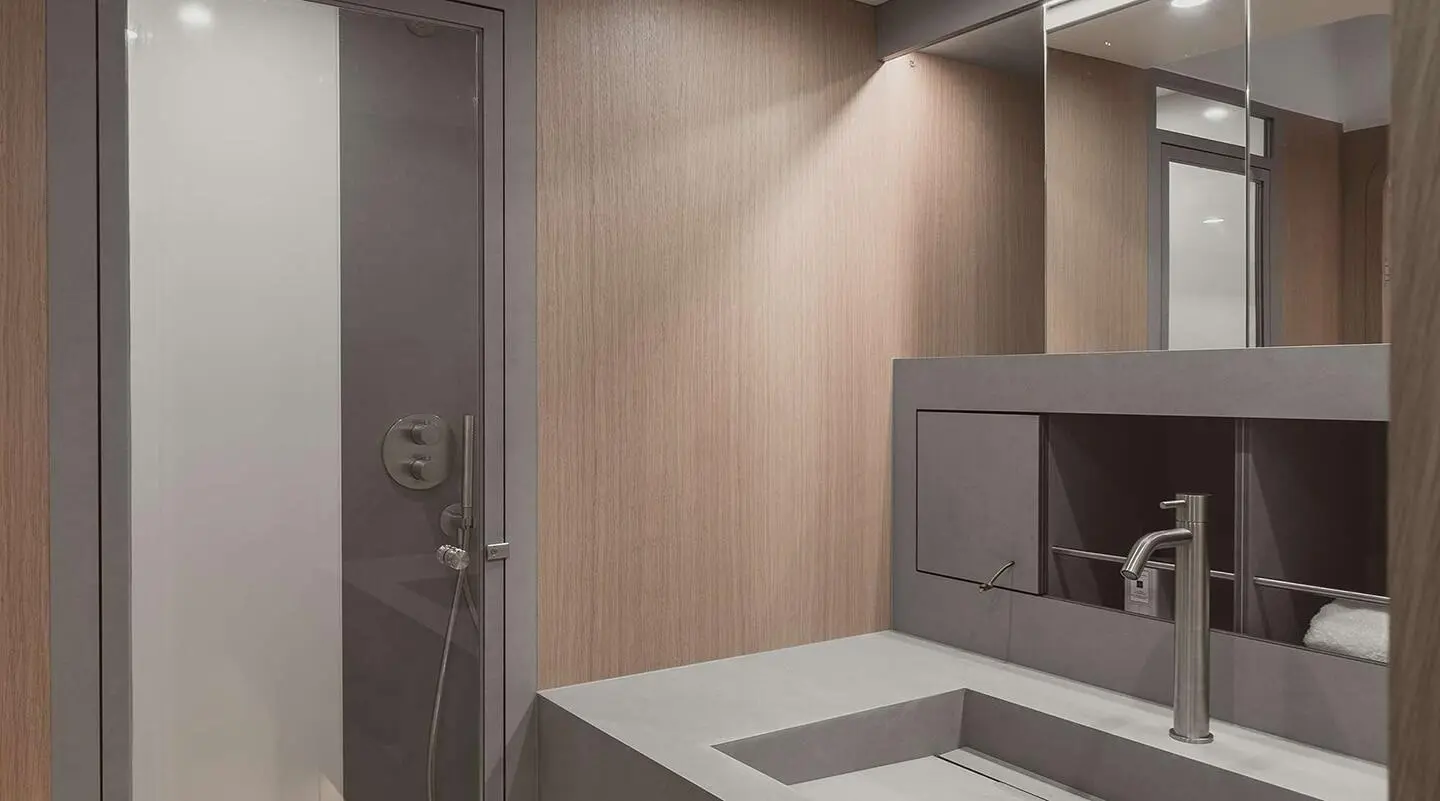 Nadamas yacht bathroom with beige wood cabinetry and a compact sink area