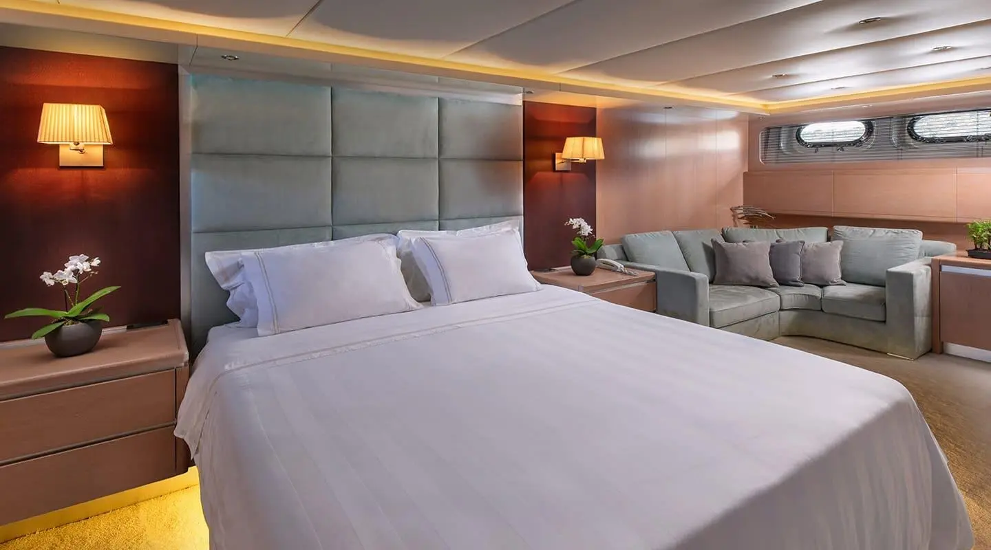 Magix yacht bedroom with two large beds, wood headboard, soft lighting