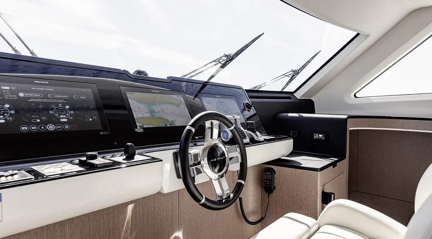 Viva II yacht cockpit interior with sleek navigation screens and polished steering wheel