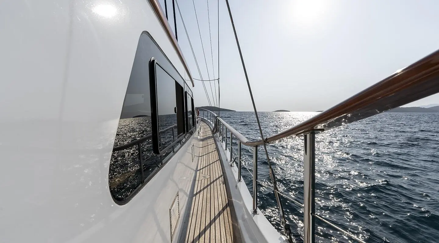 Side deck view of Artemis gulet with railing and ocean in background