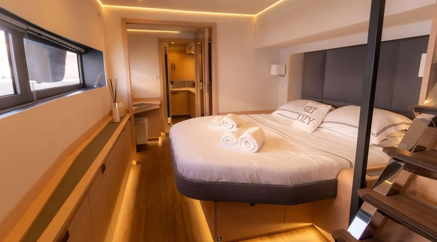 Serenissima luxury yacht cabin with king bed, soft lighting, and modern wood finishes