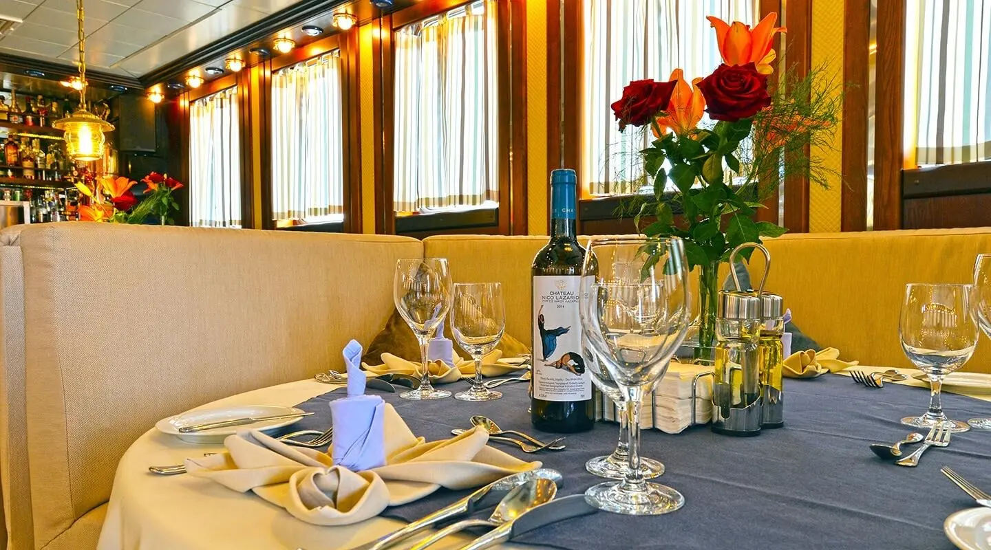 Sunset on luxury gulet yacht with dining table set for two inside