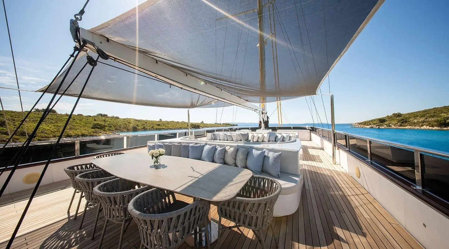 Anima Maris yacht deck with lounge seating and shade sails overhead