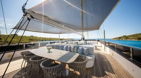 Anima Maris yacht deck with lounge seating and shade sails overhead