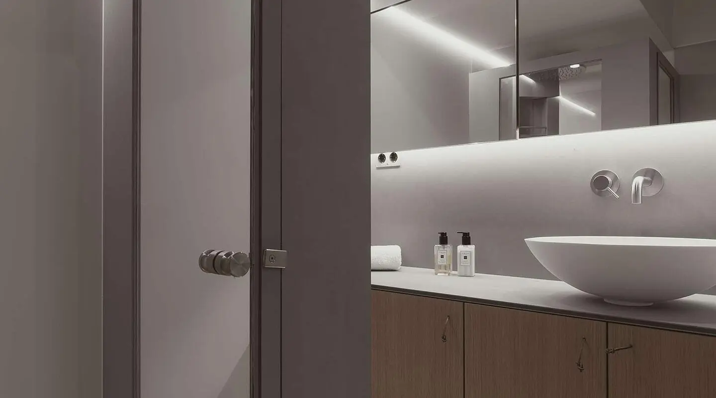Interior bathroom of Nadamas yacht with sink, mirror, and cabinetry