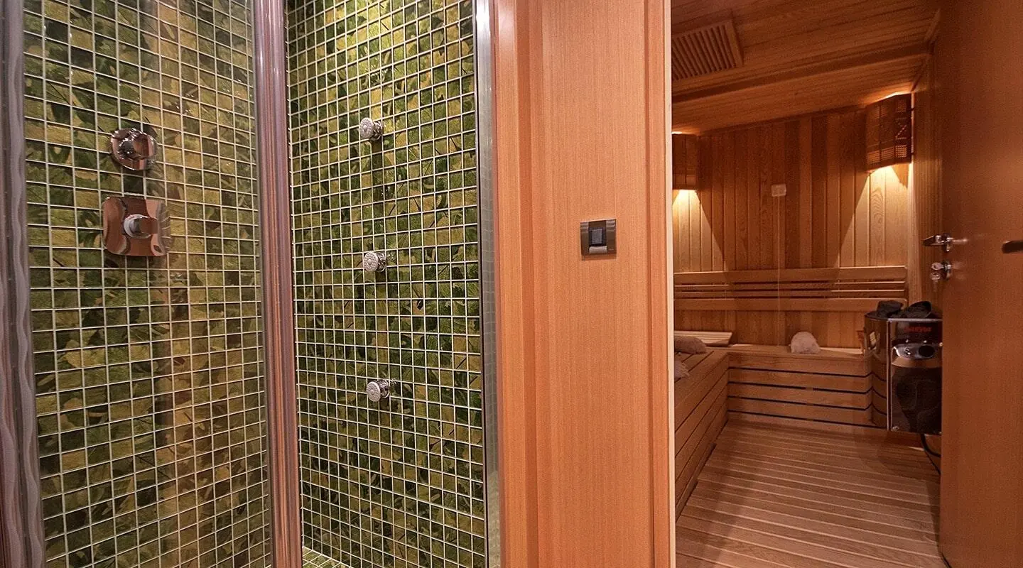 Outdoor deck with wooden interiors and a sauna room visible