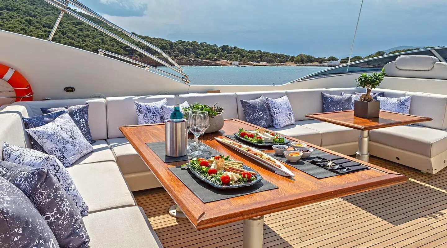 Divine motoryacht flybridge with sun loungers and a wooden deck dining area