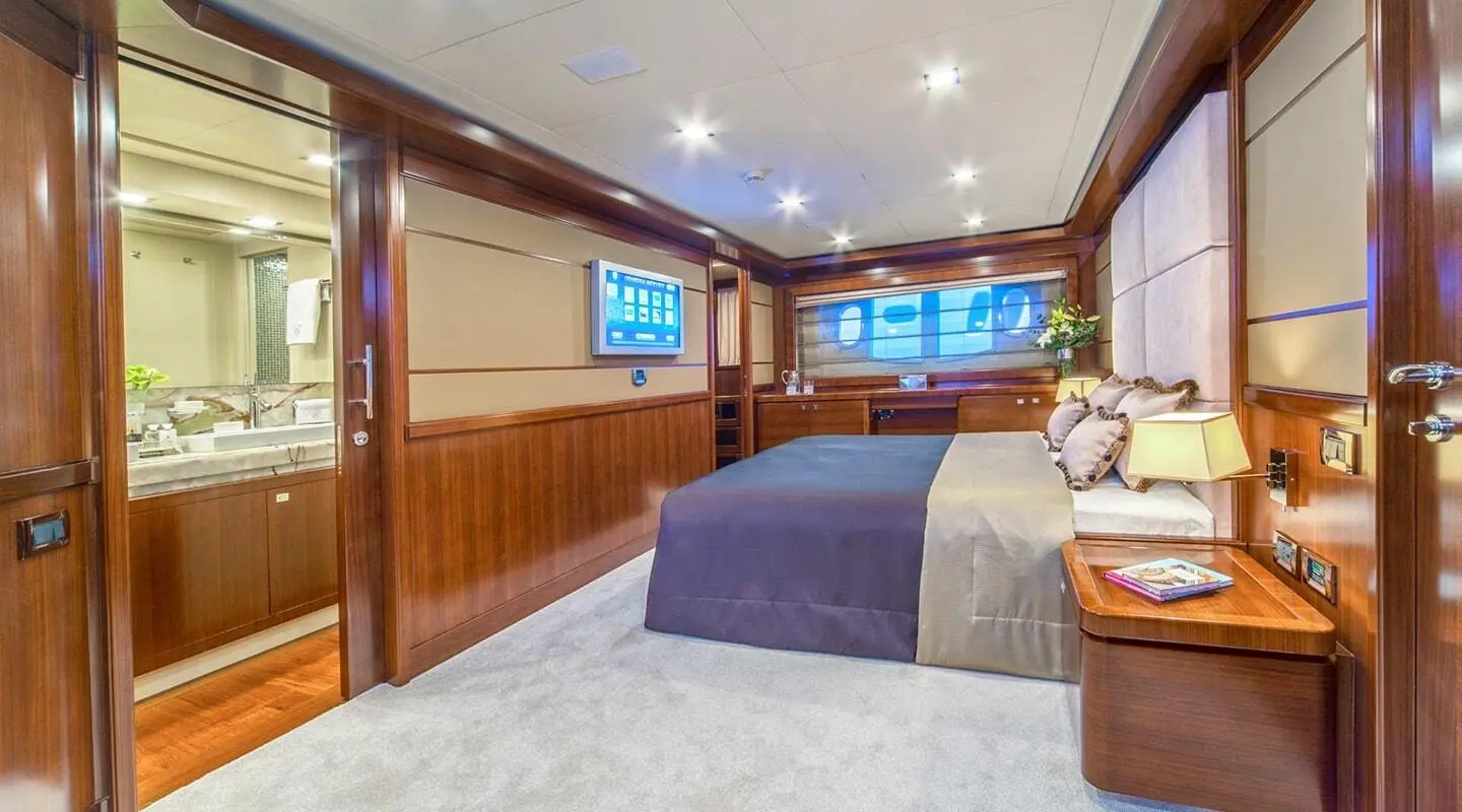 Seventh Sense master cabin with large window, wood panels, and bed