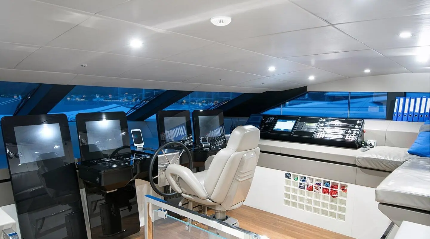 Morning Star yacht helm interior with white captain chair and navigation screens