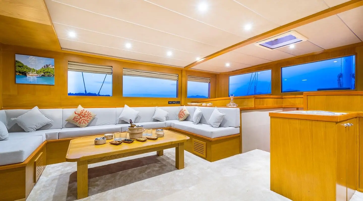 Luxurious yacht interior on Happy Days with a spacious beige lounge and wooden table