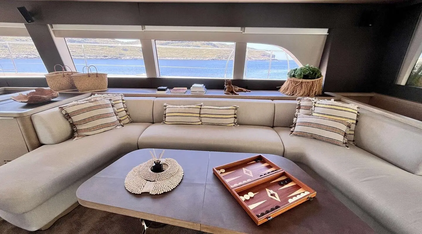 Just Marie 2 saloon aboard with curved beige seating and window view
